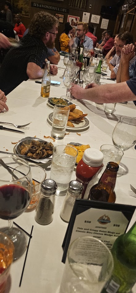 The HFFL dinner table filled with plates, drinks, and league members