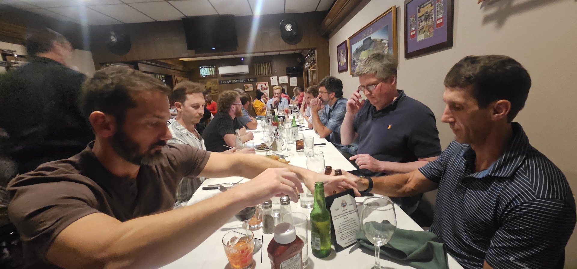 HFFL owners gathered around a long restaurant table